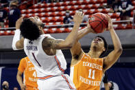 Auburn guard Jamal Johnson (1) collides with and fouls Tennessee guard Jaden Springer (11) as he takes a shot during the second half of an NCAA basketball game Saturday, Feb. 27, 2021, in Auburn, Ala. Auburn won 77-72. (AP Photo/Butch Dill)