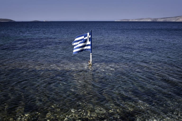 A Greek flag in the sea at Kalamitsa beach on Skyros island on July 29, 2015