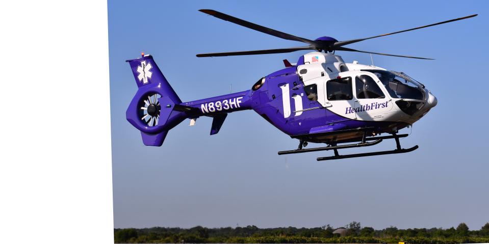 The First Flight medical helicopter hovers above its launch pad at Melbourne Orlando International Airport.