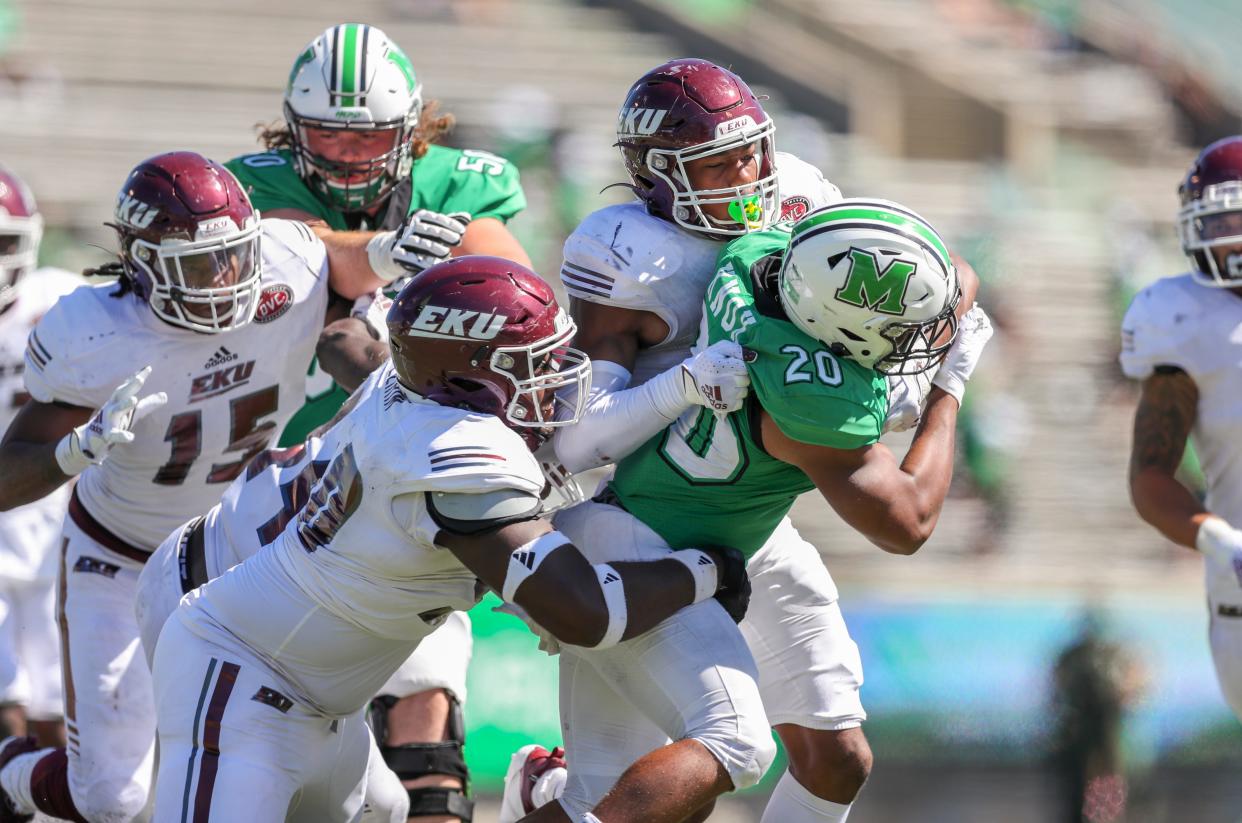 Eastern Kentucky defensive lineman Josiah Ezirim, front, helps make a tackle during a game against Marshall in 2020. Ezirim, a Hilliard Davidson graduate, later switched to right tackle. He was selected by New Orleans on Saturday in the seventh round of the NFL draft.