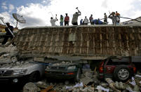 <p>People search for survivors under the rubble of a collapse building the day after an earthquake?hit Port-au-Prince, Haiti, Wednesday, Jan. 13, 2010. (Photo: Ricardo Arduengo/AP) </p>