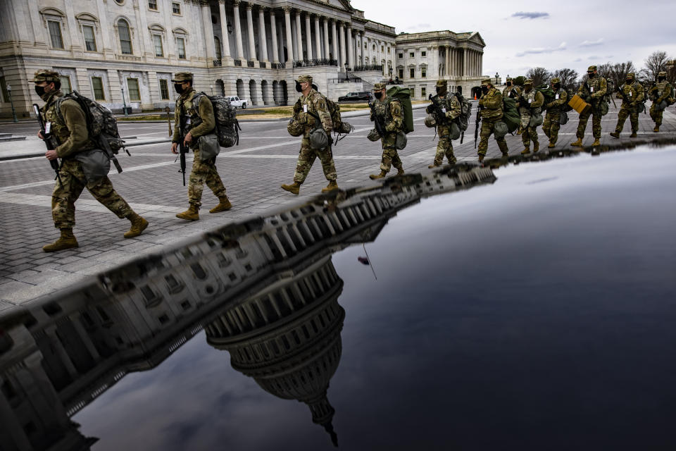 Virginia National Guard troops march across the east front of the U.S. Capitol on their way to their guard posts on Jan. 16 in Washington, DC. After the Jan. 6 riots at the U.S. Capitol, the FBI has warned of additional threats in the nation's capital and in all 50 states. (Photo: Samuel Corum via Getty Images)