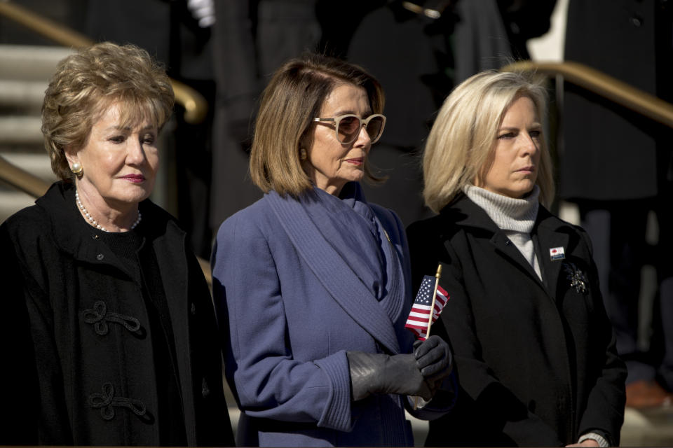 House Minority Leader Nancy Pelosi of Calif., center, and Homeland Security Secretary Kirstjen Nielsen, right, attend a wreath laying ceremony at the Tomb of the Unknown Soldier during a ceremony at Arlington National Cemetery on Veterans Day, Sunday, Nov. 11, 2018, in Arlington, Va. (AP Photo/Andrew Harnik)