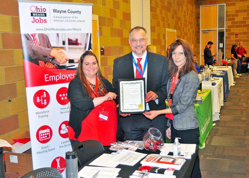 Mallorie Crank, left, Richard Owens and Tammy Mallet of Wayne County Job and Family Services pose with a proclamation from the Wayne County commissioners in recognition of In-Demand Jobs Week during the Ohio Means Jobs Career Expo at the University of Akron's Wayne College in Orrville.
(DAN STARCHER/WAYNE COUNTY COMMUNICATIONS)