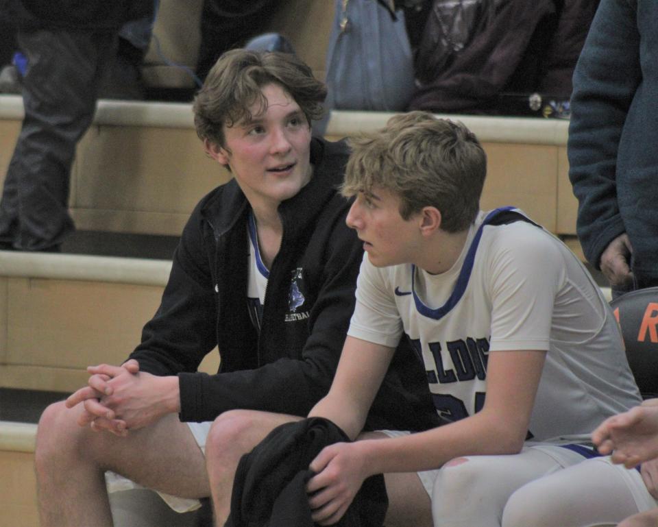 Inland Lakes senior center Sam Schoonmaker (left) looks on following Friday's district final defeat against Onaway. Schoonmaker finished with a team-high 28 points in his final game as a Bulldog.