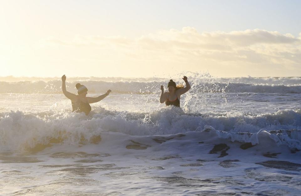 winter swimming in the sea at sunrise