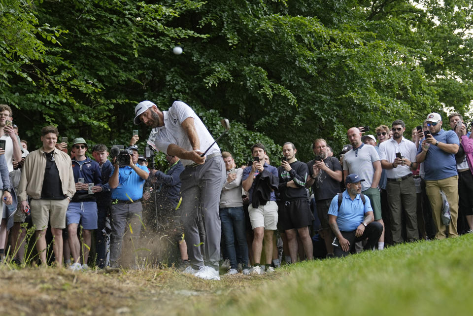 Dustin Johnson of the United States plays from the rough during the first round of the inaugural LIV Golf Invitational at the Centurion Club in St. Albans, England, Thursday, June 9, 2022. (AP Photo/Alastair Grant)