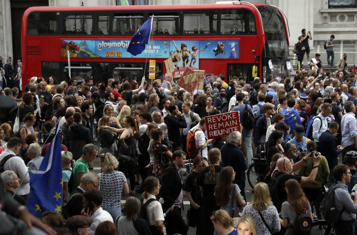 Anti-Brexit supporters gather outside the Prime Minister's residence 10 Downing Street in London, Wednesday, Aug. 28, 2019. British Prime Minister Boris Johnson asked Queen Elizabeth II on Wednesday to suspend Parliament, throwing down the gauntlet to his critics and causing outrage among opposition leaders who will have even less time to thwart a no-deal Brexit. (AP Photo/Matt Dunham)