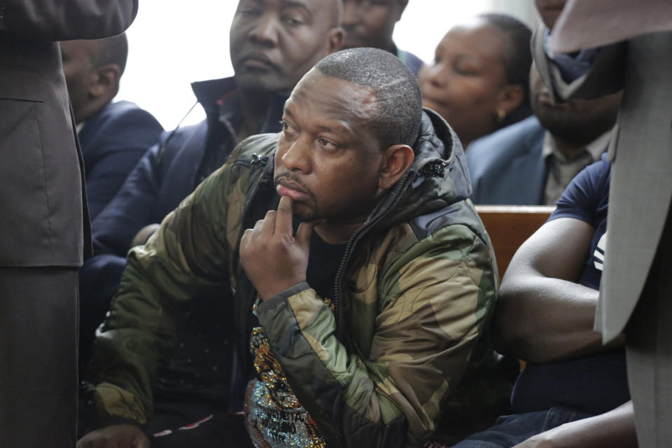 Nairobi governor Mike Gideon Mbuvi appears with other suspects accused of corruption, at the Mililani law court in Nairobi, Kenya, Monday Dec. 9, 2019. The flamboyant governor of Kenya's capital city, Nairobi, has been charged with 19 counts of graft-related charges as the country struggles to tackle runaway corruption. He denied the charges Monday, including embezzlement and money laundering. (AP Photo/Khalil Senosi)