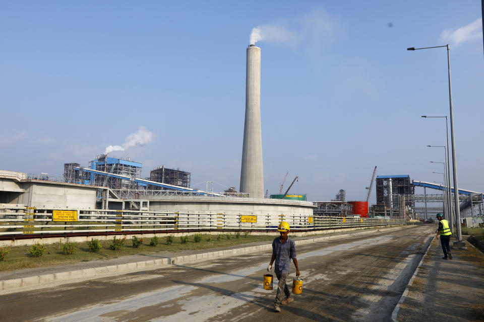 Men work near the Maitree Super Thermal Power Project near the Sundarbans, the world’s largest mangrove forest, in Rampal, Bangladesh, Monday, Oct. 17, 2022. A power plant will start burning coal as part of Bangladesh’s plan to meet its energy needs and improve living standards, officials say. (AP Photo/Al-emrun Garjon)