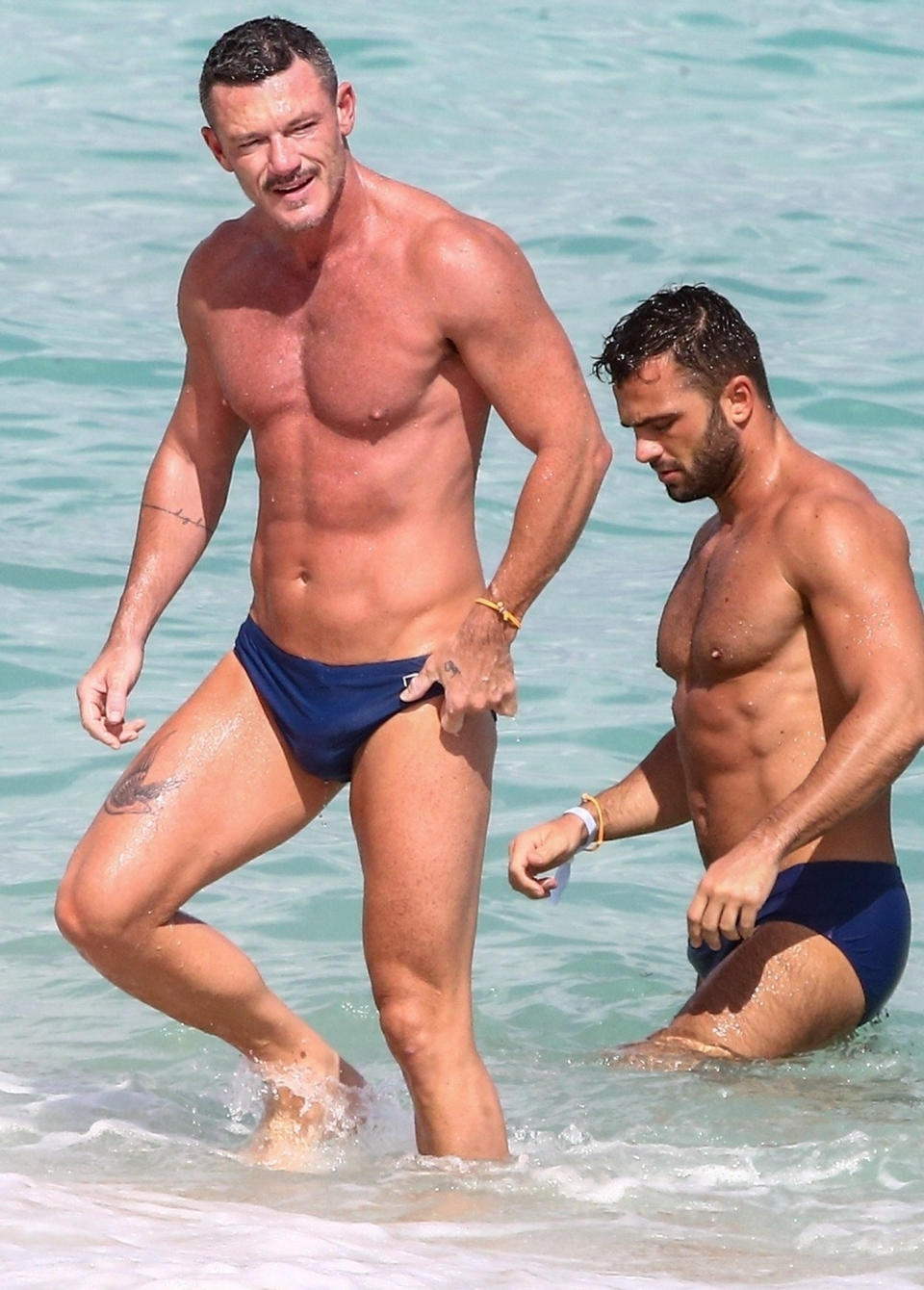 <p>Luke Evans enjoys a beach day with a friend on Tuesday in Miami.</p>