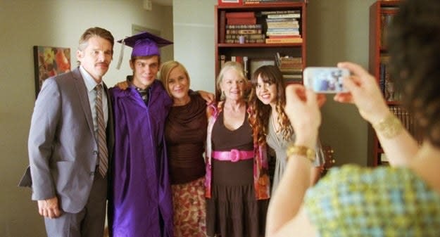 A family poses for a boy's graduation picture in "Boyhood"