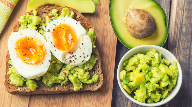 avocado toast next to bowl of mashed avocado