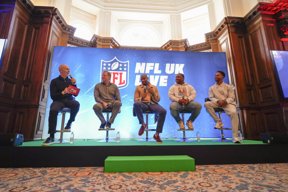 NFL Commissioner Roger Goodell, second left, Osi Umenyiora, third left, Maurice Jones-Drew, second right, and Victor Cruz, right, attend the International Series Fan Forum, hosted by Neil Reynolds, left, in London, Saturday, Oct. 8, 2022.(AP Photo/Alberto Pezzali)