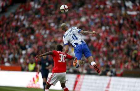 Benfica's Anderson Talisca (L) fights for the ball with Porto's Maicon Roque during their Portuguese premier league soccer match at Luz stadium in Lisbon April 26, 2015. REUTERS/Rafael Marchante
