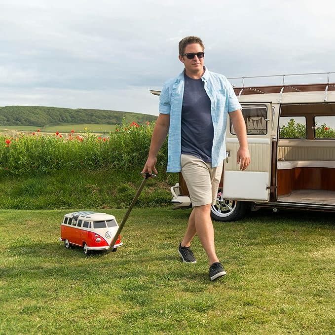 a man pulling a red rolling ice chest