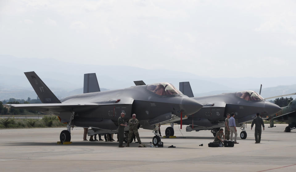 FILE - U.S. military personnel work near F-35 fighter jet of the Vermont Air National Guard, parked in the military base at Skopje Airport, North Macedonia, on June 17, 2022. Government officials said Monday, Jan. 9, 2023, that Canada has finalized an agreement with Lockheed Martin Corp and the United States government to purchase 88 F-35 fighter jets. (AP Photo/Boris Grdanoski, File)