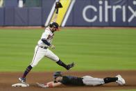 Atlanta Braves' Dansby Swanson makes forces out Miami Marlins' Corey Dickerson during the eighth inning in Game 2 of a baseball National League Division Series Wednesday, Oct. 7, 2020, in Houston. (AP Photo/Michael Wyke)