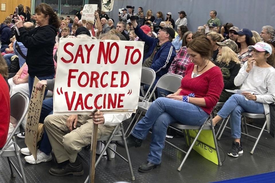 FILE - In this Wednesday. Oct. 13, 2021, file photo, audience members gather during a meeting of New Hampshire's Executive Council in Concord, N.H. Republicans in New Hampshire are struggling to contain a wing of their party that is promoting conspiracy views around the Covid-19 vaccine and pushing back, sometimes aggressively, regarding federal mandates to get the shot. (AP Photo/Holly Ramer, File)