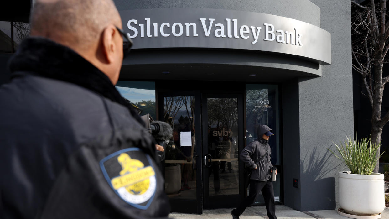 A security guard watches a customer leave a Silicon Valley Bank office 