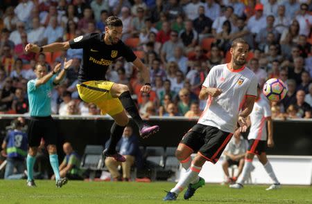 Football Soccer - Spanish Liga - Valencia v Atletico Madrid - Mestalla Stadium - Valencia, Spain - 2/10/16. Atletico Madrid's Yannick Ferreira (C) and Valencia's Mario Suarez in action. REUTERS/Heino Kalis