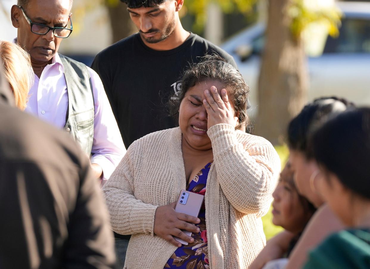 Geydi Pop mourns a family member on Shadywood Drive in South Austin on Wednesday December 6, 2023, who was shot and killed on Tuesday.