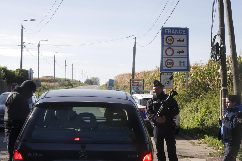 French police officers check a car near Neuville, near the France-Belgium border, Tuesday, Oct. 17, 2023 as France reinforced security at the France-Belgium border. Police in Belgium on Tuesday shot dead a suspected Tunisian extremist accused of killing two Swedish soccer fans in a brazen shooting on a Brussels street before disappearing into the night. (AP Photo/Michel Spingler)