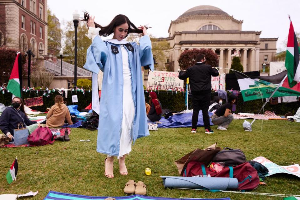 A Columbia University student taking graduation pictures amid the anti-Israel protests on campus on April 21, 2024. James Keivom