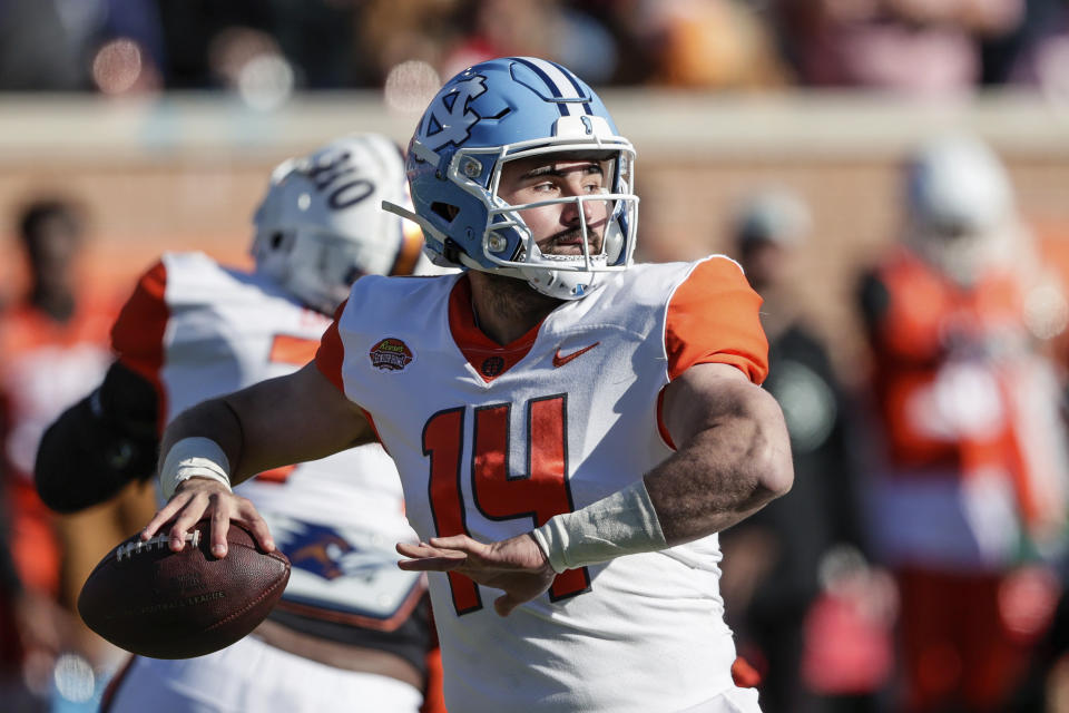 American Team quarterback Sam Howell, of North Carolina, throws a pass during the first half of an NCAA Senior Bowl college football game, Saturday, Feb. 5, 2022, in Mobile, Ala. (AP Photo/Butch Dill)