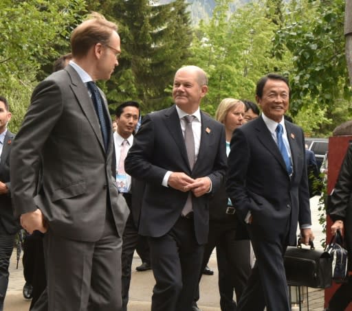 German Finance Minister Olaf Scholz (C) and his Japanese counterpart Taro Aso (R), attend the opening of the G7 finance ministers and central bank governors conference in Whistler, British Columbia on May 31, 2018
