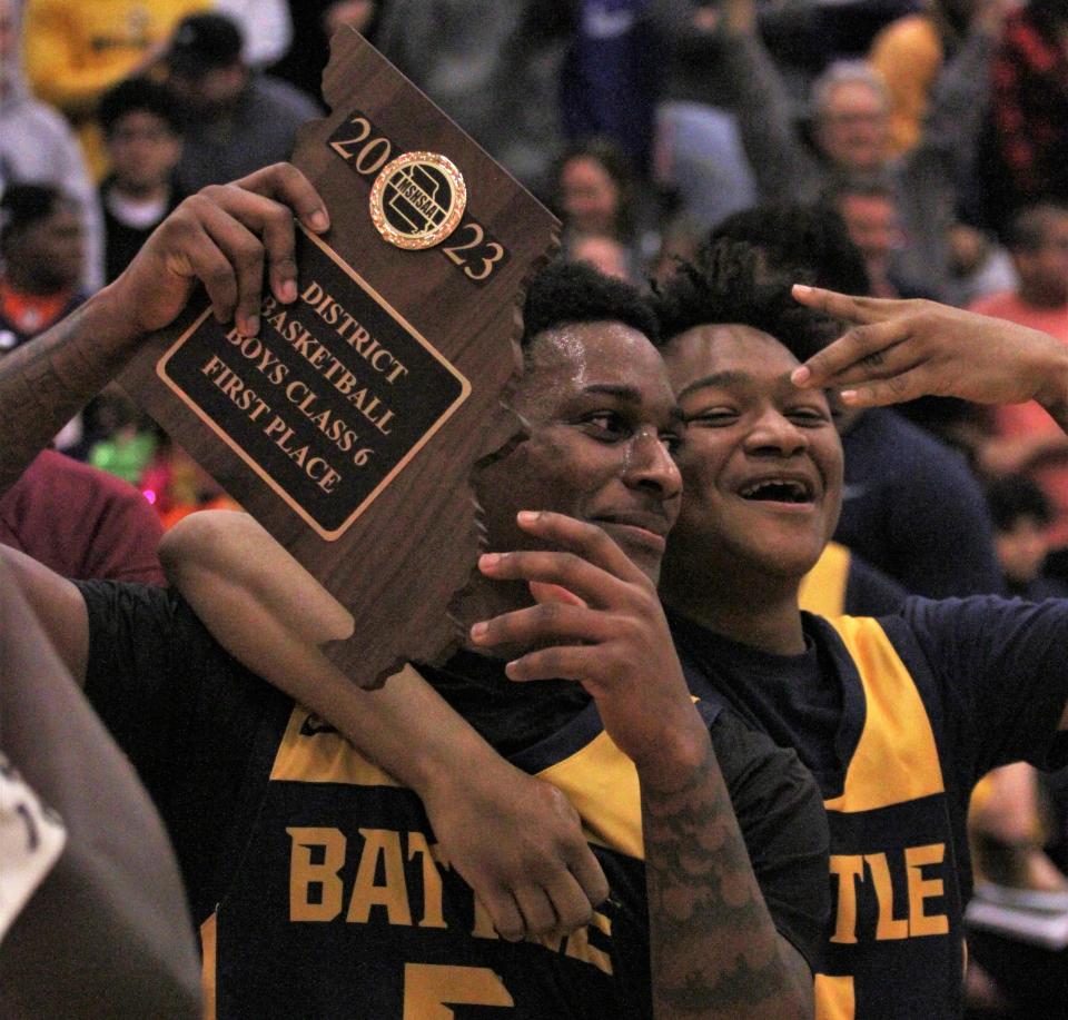 Battle's Tay Patrick shows off the the Class 6 District 7 trophy after winning the Class 6 District 7 championship game on March 6, 2023, at Hickman High School.