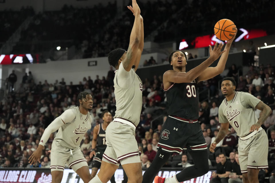 South Carolina forward Collin Murray-Boyles (30) attempts a lay up past Mississippi State forward Tolu Smith (1), left, during the first half of an NCAA college basketball game, Saturday, March 9, 2024, in Starkville, Miss. (AP Photo/Rogelio V. Solis)