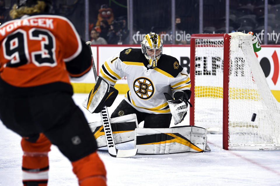 Boston Bruins goaltender Jeremy Swayman watches the puck after making a save during the first period of an NHL hockey game against the Philadelphia Flyers, Saturday, April 10, 2021, in Philadelphia. (AP Photo/Derik Hamilton)