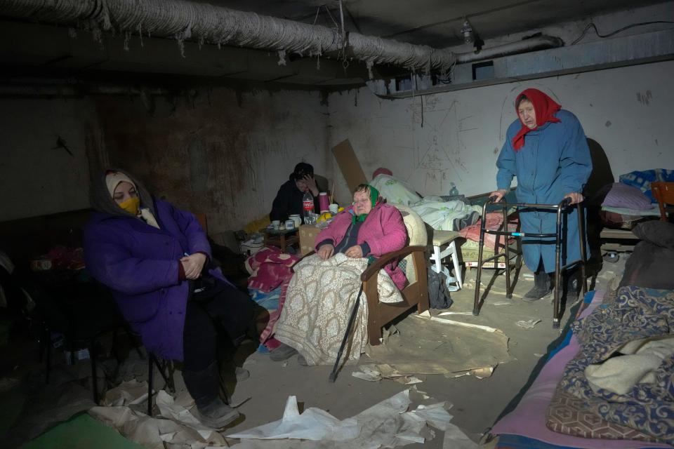 Elderly residents hide in a basement for shelter with no electricity, water or food in the center of the town of Irpin, some 25 km (16 miles) northwest of Kyiv, Friday, March 11, 2022. Kyiv's northwest suburbs such as Irpin and Bucha had endured Russian shellfire and bombardments for over a week, prompting residents to leave their homes.