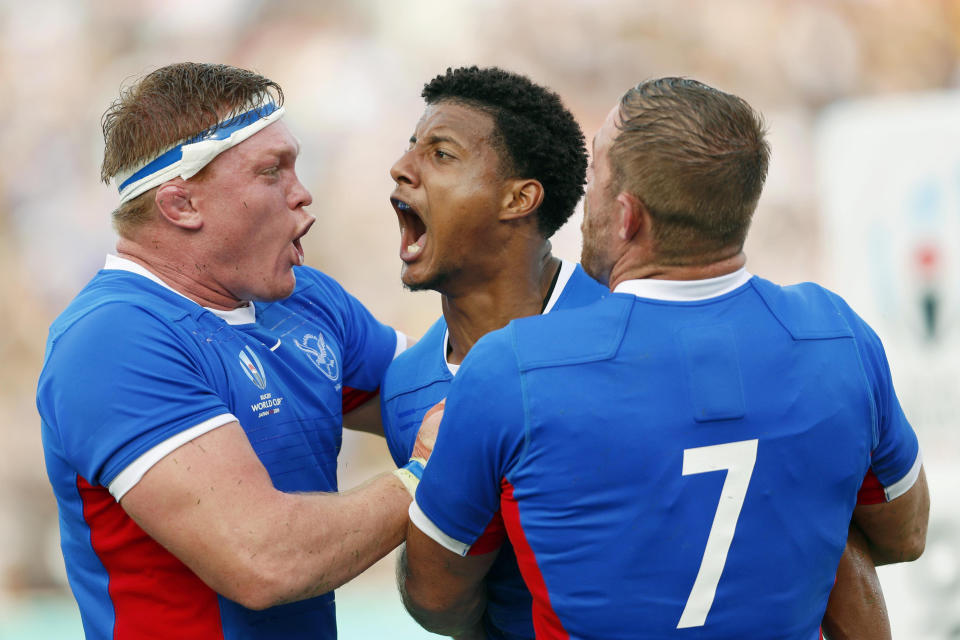 FILE - In this Sept. 22, 2019, file photo, Namibia's Chad Plato, center, reacts with teammates after scoring a try against Italy during the Rugby World Cup Pool B game between Italy and Namibia in Osaka, western Japan. Nambia will play South Africa in the Pool B game on Saturday, Sept. 28. (Ichiro Sakano/Kyodo News via AP, File)