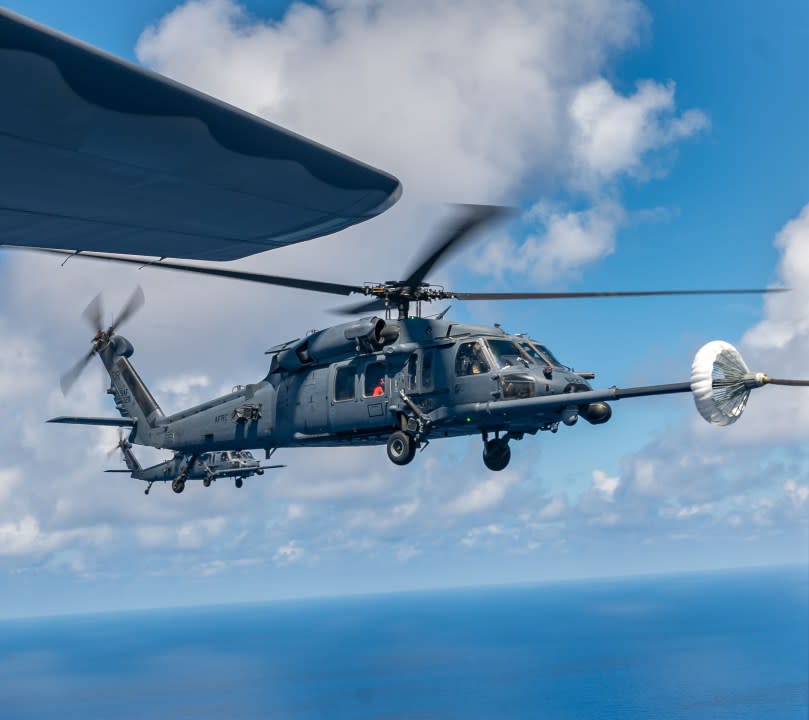 An HH-60G Pave Hawk helicopter receives fuel from an HC-130J Combat King II during a civilian medical airlift operation of a critical patient aboard a cruise ship more than 350 miles off the eastern coast of U.S. May 4, 2024. The mission, carried out by two HH-60s, two HC-130Js, and two teams of combat rescue officers and pararescuemen required three air-to-air refuelings. The more than 8-hour mission covered more than 1,200 miles round trip over open ocean. (U.S. Air Force photo by Tech. Sgt. Darius Sostre-Miroir)