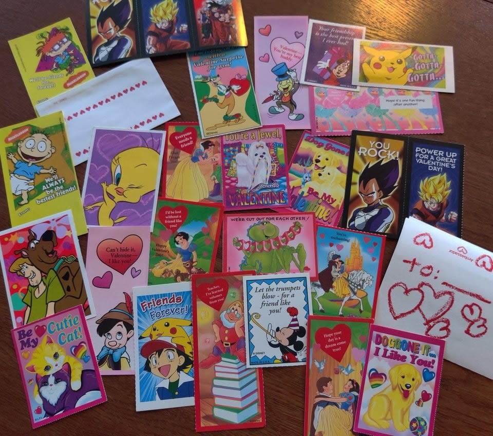 A bunch of '90s Valentine's Day cards spread out on a table