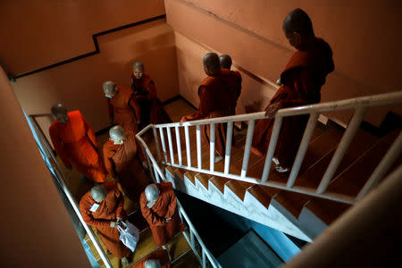 Novice monks walk in line before receiving food offerings at the Songdhammakalyani monastery, Nakhon Pathom province, Thailand, December 7, 2018. REUTERS/Athit Perawongmetha