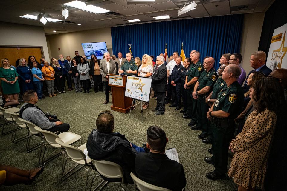 Polk Sheriff Grady Judd; Polk County Commissioner Bill Braswell; Denise Harrison, community program coordinator, and Bob Rihn, CEO of Tri County Human Services, announce the new STARR mental health program at the Sheriff's Office in Winter Haven on Wednesday.