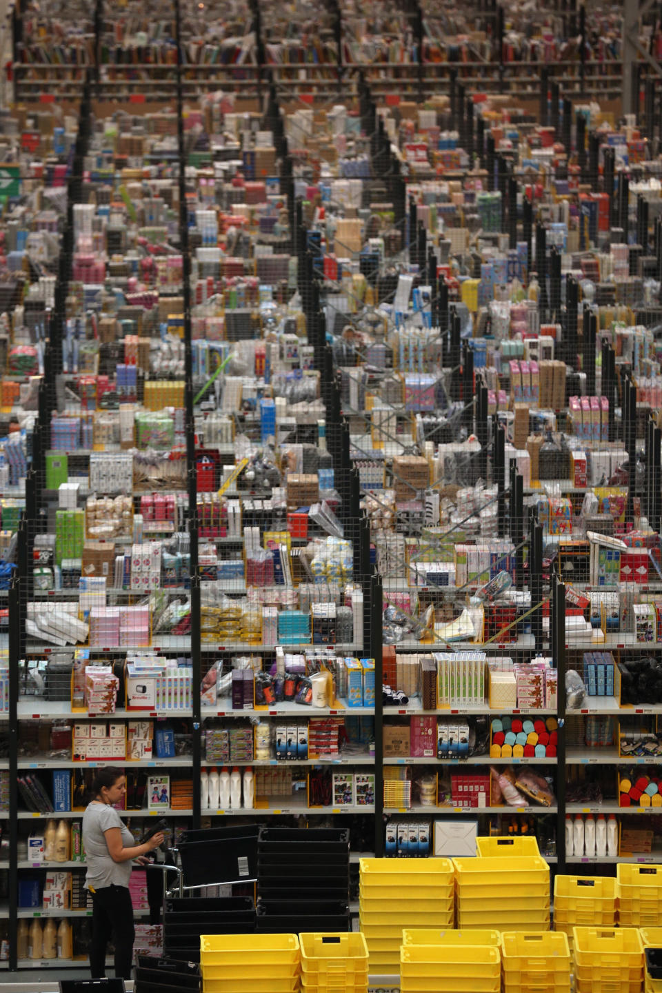 PETERBOROUGH, ENGLAND - NOVEMBER 28:  Employees select and dispatch items in the huge Amazon 'fulfilment centre' warehouse on November 28, 2013 in Peterborough, England. The online retailer is preparing for 'Cyber Monday', as it predicts the busiest day for online shopping in the UK will fall on Monday December 2nd this year. On Cyber Monday in 2012 amazon.co.uk recorded over 3.5 million individual items ordered, which equates to 41 items purchased per second. The Peterborough fulfilment centre is 500,000 sq ft, equivalent to approximately seven football pitches in floor area. Amazon are due to employ more than 1,000 seasonal staff to cope with increased demand in the run up to Christmas.  (Photo by Oli Scarff/Getty Images)