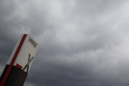 A logo of Lanxess is seen next to dark clouds at Cologne Bonn airport