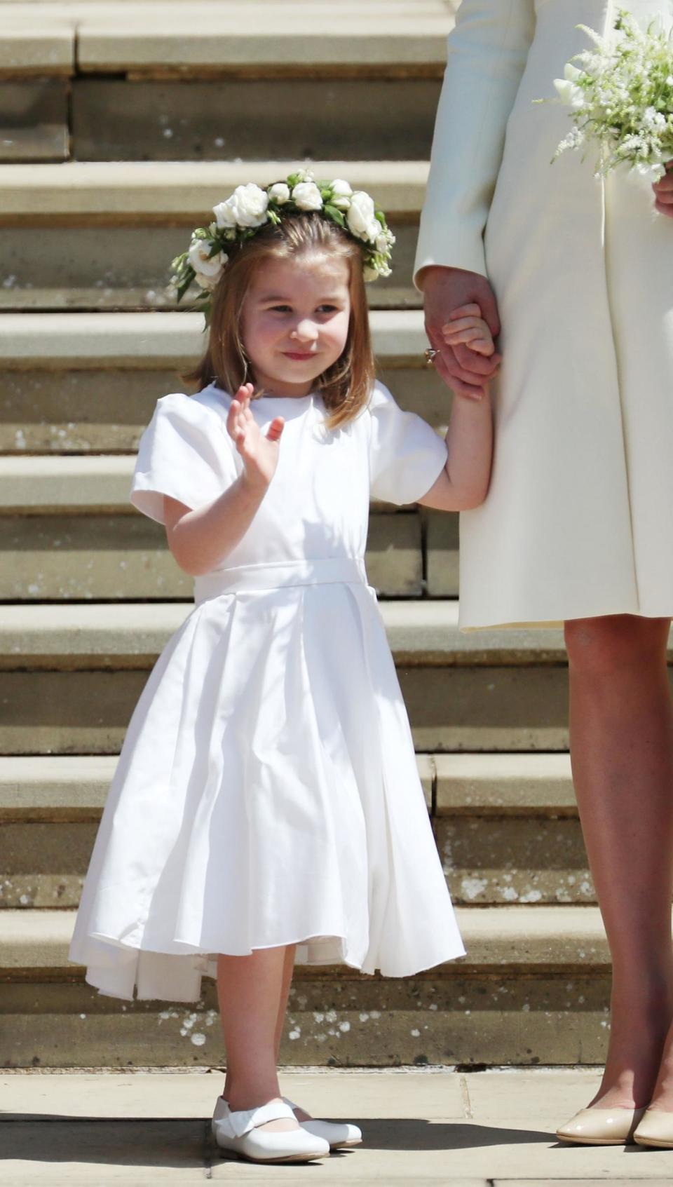 Princess Charlotte waves to crowds on the steps of St George's Chapel (REUTERS)