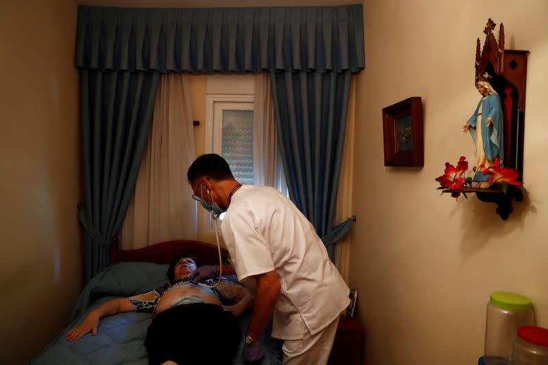 Comunidad de Madrid home care doctor Balsalobre treats patient Carmen Garcia at her house in Madrid