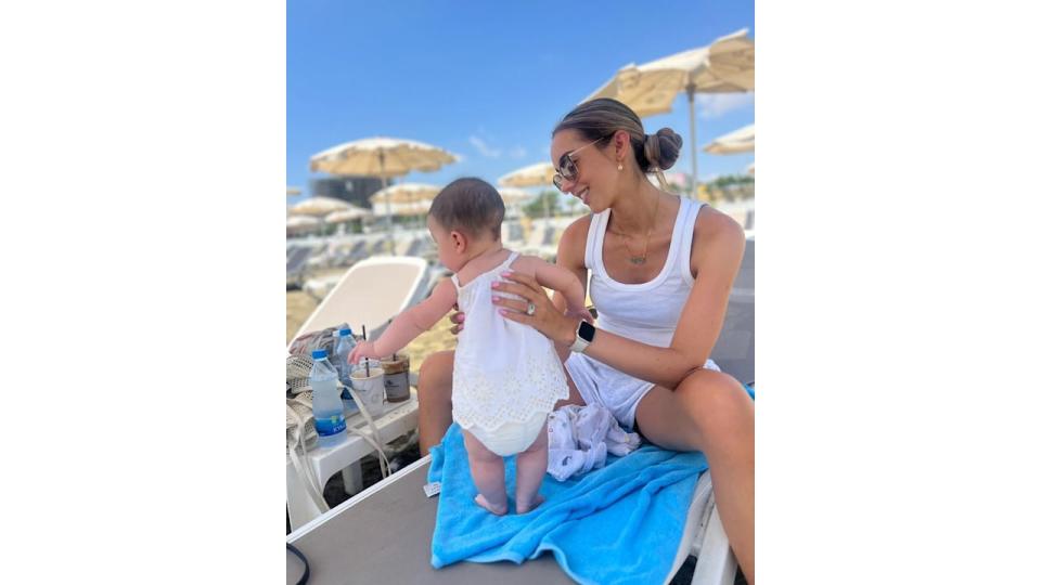 mother with baby daughter at beach