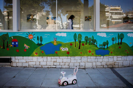 A social worker walks inside the Model National Nursery of Kallithea, in Athens, Greece, March 3, 2017. REUTERS/Alkis Konstantinidis