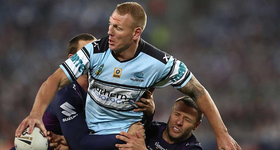 Luke Lewis of the Sharks is tackled during the 2016 NRL Grand Final match between the Cronulla Sharks and the Melbourne Storm at ANZ Stadium in Sydney.