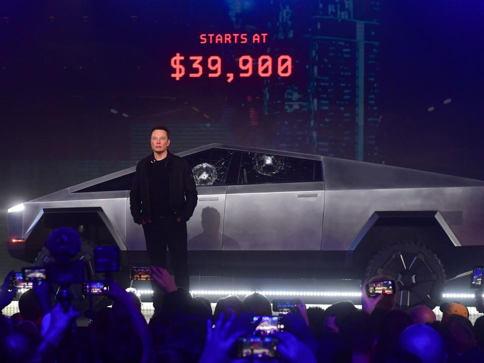 Tesla co-founder and CEO Elon Musk stands in front of the all-electric Tesla's Cybertruck.