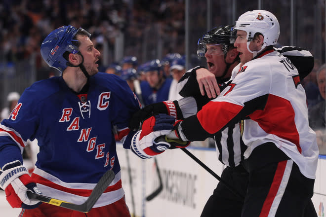 NEW YORK, NY - APRIL 26: Linesman Bryan Pancich #94 separates Kyle Turris #7 of the Ottawa Senators and Ryan Callahan #24 of the New York Rangers after a second period Rangers goal in Game Seven of the Eastern Conference Quarterfinals during the 2012 NHL Stanley Cup Playoffs at Madison Square Garden on April 26, 2012 in New York City. (Photo by Bruce Bennett/Getty Images)