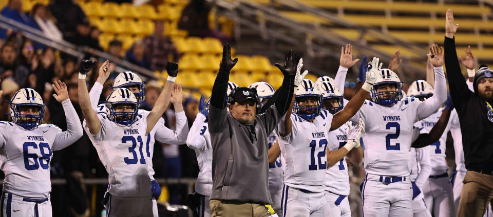 Wyoming head coach Aaron Hancock and the team react after a made field goal during the Cowboys' Division IV OHSAA state semifinal against Steubenville Saturday, Nov 26, 2022.