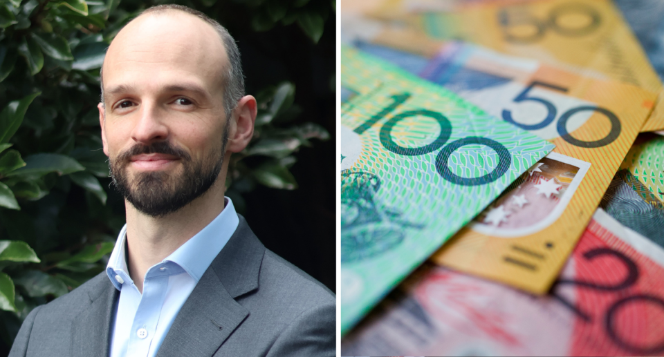 Bendigo Bank's Jason Gordon next to pile of Aussie money